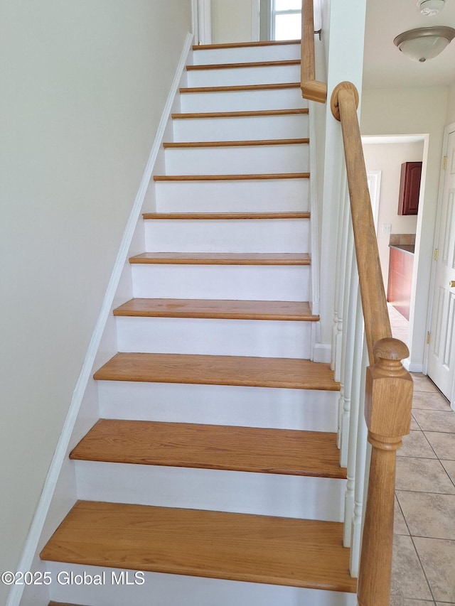staircase featuring tile patterned flooring