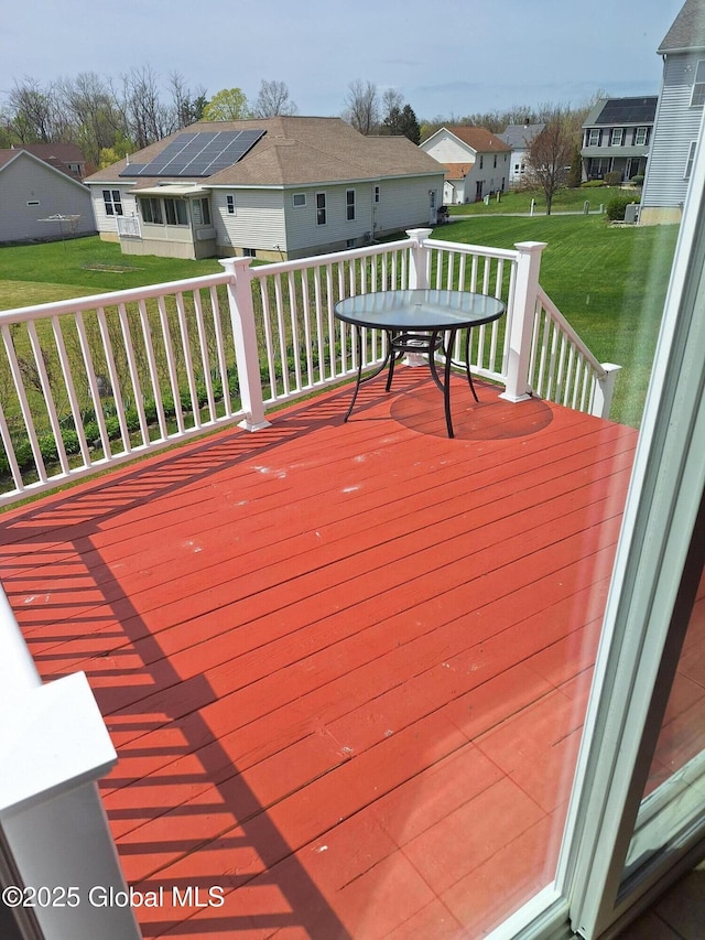 wooden terrace featuring a yard and a residential view