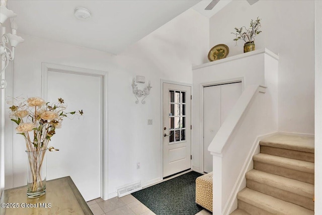 tiled foyer entrance with stairway and visible vents