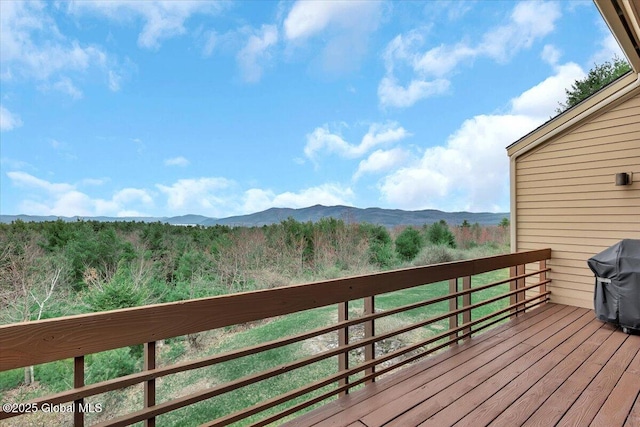 deck featuring a grill and a mountain view