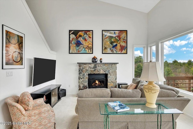 living room featuring baseboards, carpet, high vaulted ceiling, and a stone fireplace
