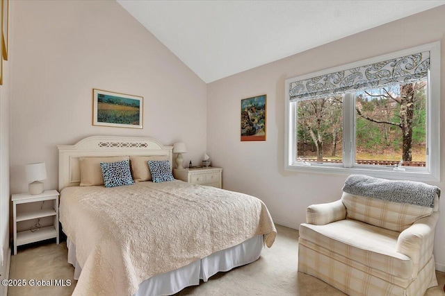 bedroom featuring lofted ceiling, baseboards, and light carpet