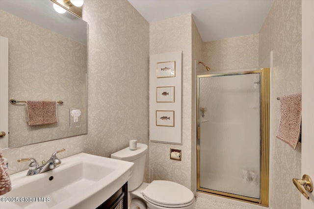 full bath featuring a shower stall, toilet, vanity, and wallpapered walls