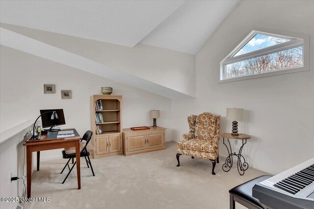 office space featuring light colored carpet and lofted ceiling