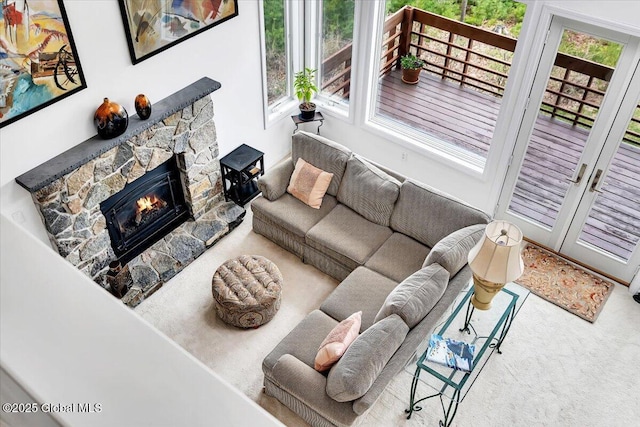 living area with a fireplace and carpet flooring