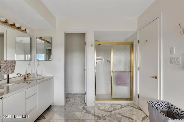 full bath featuring a shower stall, marble finish floor, baseboards, and vanity