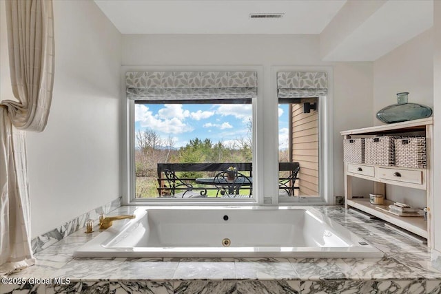 full bath featuring a tub with jets and visible vents