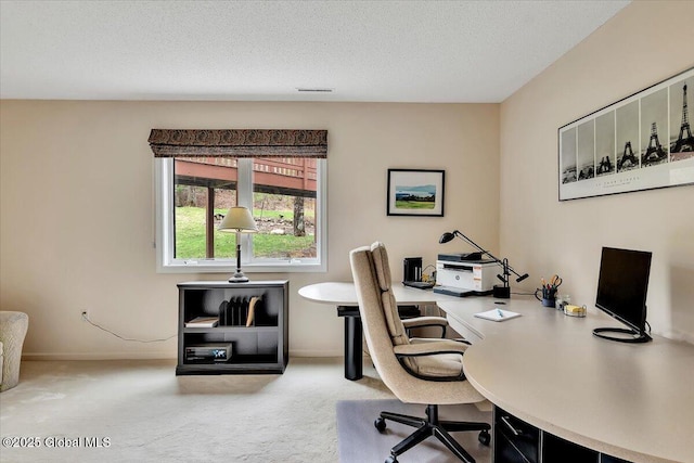 office area with baseboards, carpet flooring, and a textured ceiling