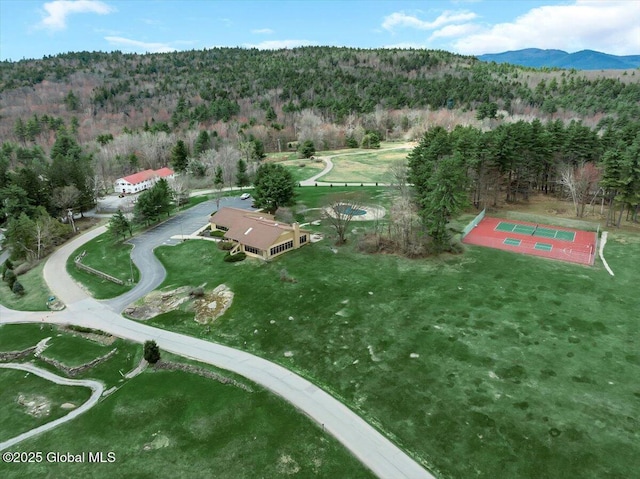 birds eye view of property featuring a mountain view and a wooded view