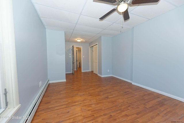 173 Lancaster St, Albany, NY 12210 - empty room featuring a baseboard heating unit, baseboards, ceiling fan, a paneled ceiling, and wood finished floors