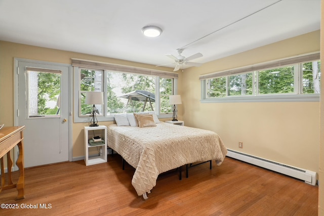 5 Overlook Ln B/D, Unit B/D Warrensburg, NY 12817 - bedroom with baseboard heating and light wood-type flooring