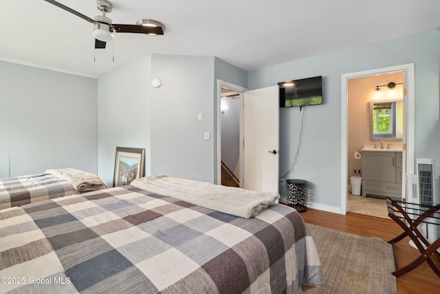 5 Overlook Ln B/D, Unit B/D Warrensburg, NY 12817 - bedroom featuring wood finished floors, connected bathroom, and a ceiling fan