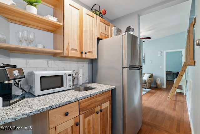 5 Overlook Ln B/D, Unit B/D Warrensburg, NY 12817 - kitchen featuring white microwave, open shelves, freestanding refrigerator, and light wood-type flooring
