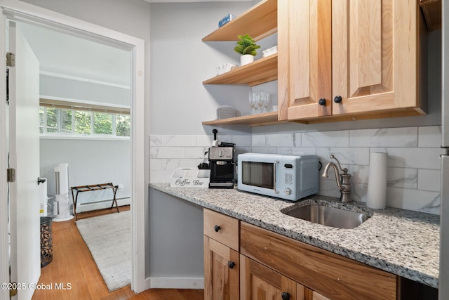 5 Overlook Ln B/D, Unit B/D Warrensburg, NY 12817 - kitchen with white microwave, a baseboard radiator, open shelves, decorative backsplash, and light stone countertops