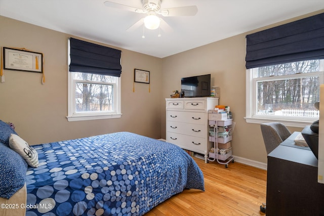 bedroom with baseboards, a ceiling fan, and wood finished floors