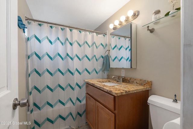 bathroom featuring toilet, a shower with curtain, and vanity