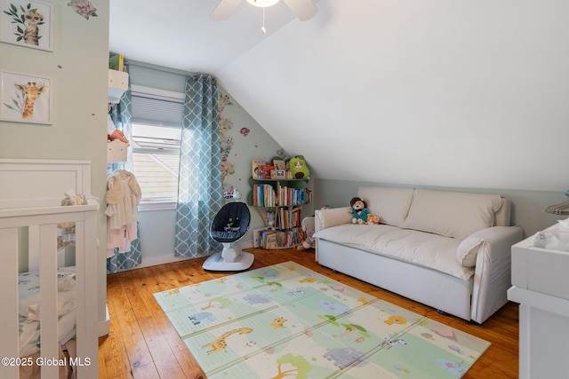 bedroom featuring ceiling fan, lofted ceiling, and hardwood / wood-style floors