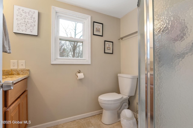 full bath featuring baseboards, a shower with door, toilet, and vanity
