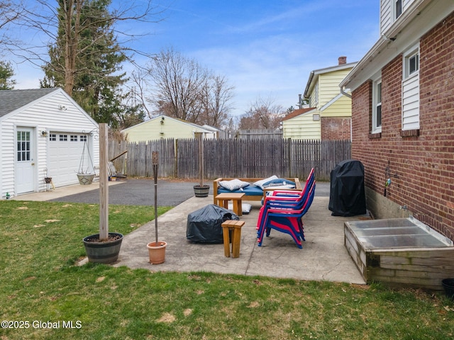 view of yard with a patio, fence, and an outbuilding