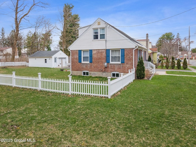 exterior space with a fenced front yard, a yard, and brick siding