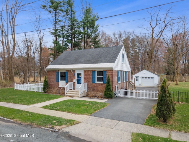 view of front of home with brick siding, an outbuilding, roof with shingles, and a garage