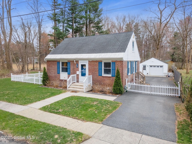 view of front of home featuring an outdoor structure, a garage, fence, roof with shingles, and brick siding