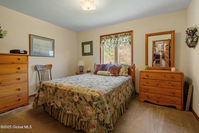 bedroom with baseboards and light colored carpet