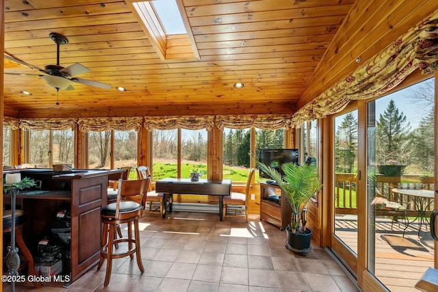 sunroom with a skylight, wood ceiling, and plenty of natural light
