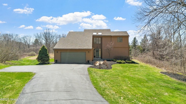 view of front of property with an attached garage, driveway, and a front yard