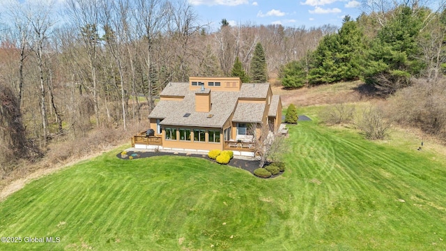 aerial view featuring a wooded view
