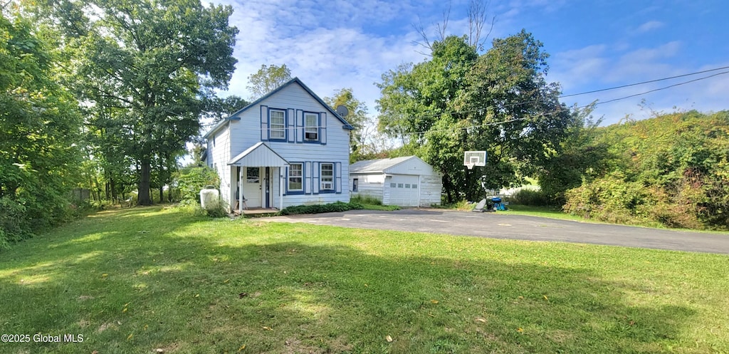 traditional home featuring an outdoor structure and a front lawn