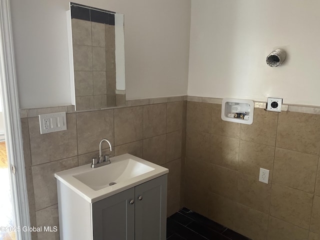 bathroom with tile walls and vanity