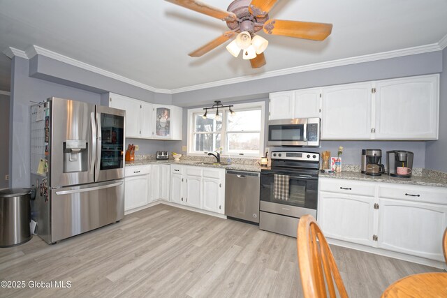 18 Molly White Dr, Coxsackie, NY 12051 - kitchen with light wood finished floors, white cabinetry, ornamental molding, and appliances with stainless steel finishes