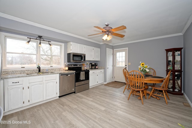 18 Molly White Dr, Coxsackie, NY 12051 - kitchen with a sink, a ceiling fan, light wood finished floors, white cabinetry, and stainless steel appliances