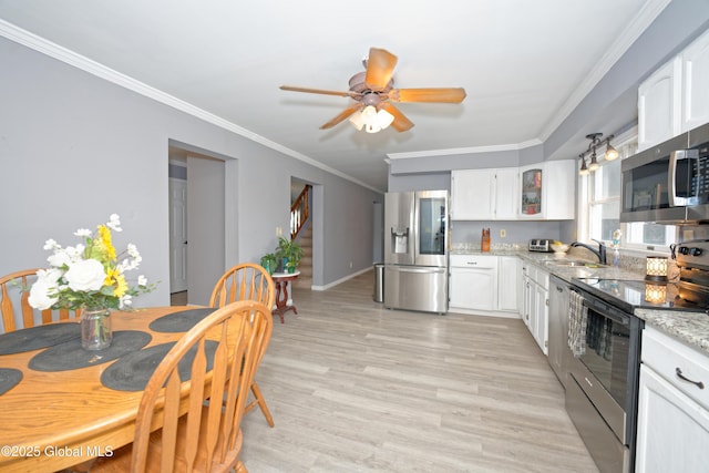 18 Molly White Dr, Coxsackie, NY 12051 - kitchen featuring crown molding, appliances with stainless steel finishes, ceiling fan, and white cabinets
