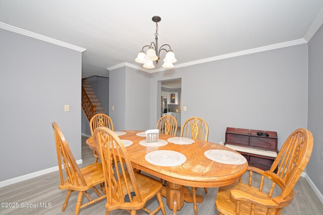 18 Molly White Dr, Coxsackie, NY 12051 - dining space featuring wood finished floors, a notable chandelier, ornamental molding, and stairs