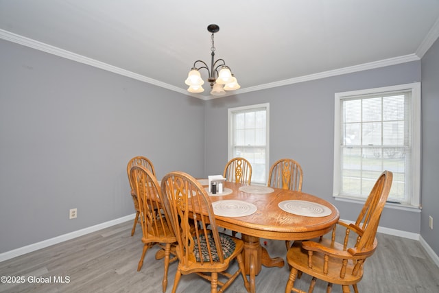 18 Molly White Dr, Coxsackie, NY 12051 - dining space with crown molding, baseboards, a chandelier, and wood finished floors