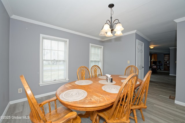 18 Molly White Dr, Coxsackie, NY 12051 - dining space featuring crown molding, baseboards, a notable chandelier, and light wood-style floors