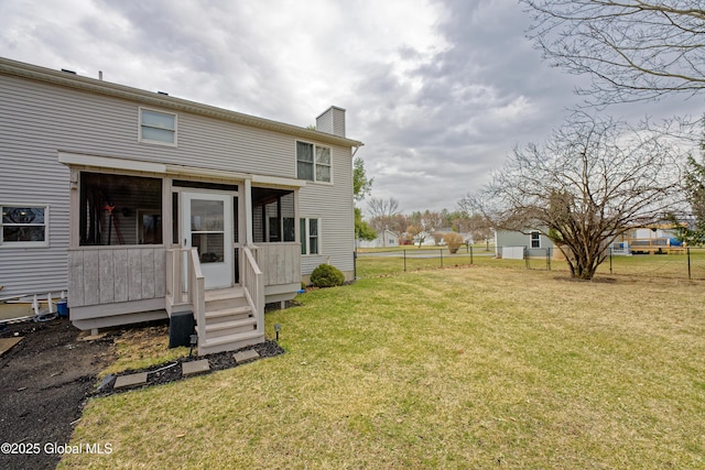 18 Molly White Dr, Coxsackie, NY 12051 - rear view of property with fence, a sunroom, a lawn, and a chimney