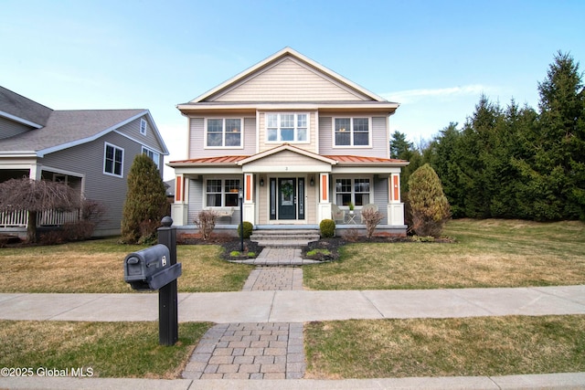 view of front of house with metal roof, a standing seam roof, a front lawn, and a porch