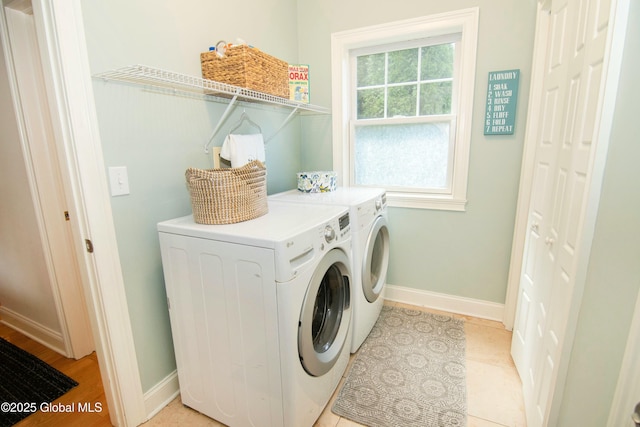 laundry room featuring washer and clothes dryer, laundry area, and baseboards