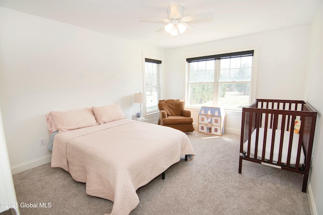 bedroom featuring baseboards, a ceiling fan, and carpet