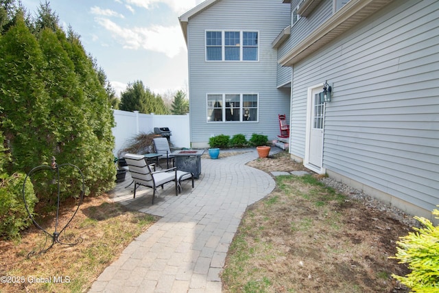 view of yard featuring an outdoor fire pit, fence, and a patio