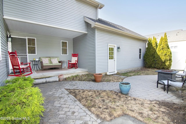 view of patio featuring a fire pit and a porch