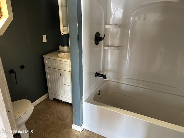 bathroom with shower / bathing tub combination, vanity, toilet, baseboards, and tile patterned floors