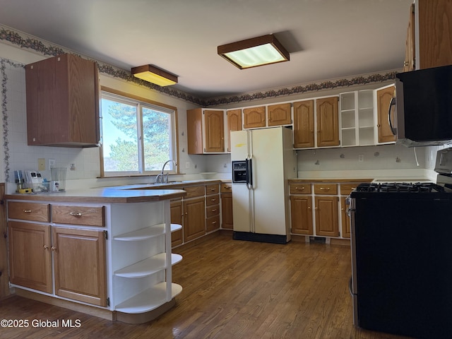 kitchen with light countertops, stainless steel appliances, open shelves, and dark wood finished floors