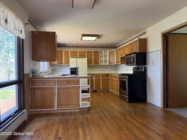 kitchen with stainless steel appliances, open shelves, a sink, and a baseboard radiator