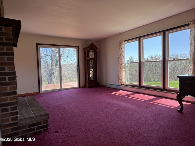 unfurnished living room featuring a healthy amount of sunlight, baseboards, carpet flooring, and a baseboard heating unit