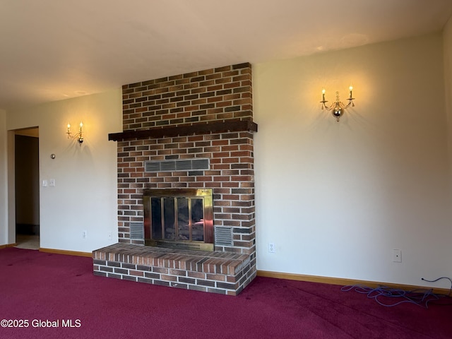 unfurnished living room with carpet flooring, baseboards, visible vents, and a fireplace