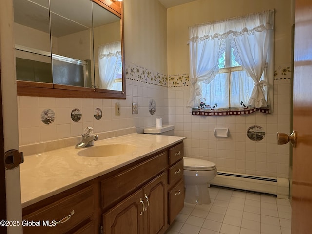 full bathroom with tile walls, vanity, tile patterned floors, a baseboard heating unit, and toilet